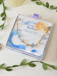 Moon and Sea bracelet with moonstone and aquamarine chip stones laid on Laganna Moon and Sea gift box, handmade Sri Lankan gold wire wrapped dual crystal bracelet for new beginnings and courage