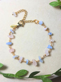 Laganna handmade Petal and Sea gold wire wrapped bracelet with rose quartz and aquamarine for love and calm on soft background with leaves