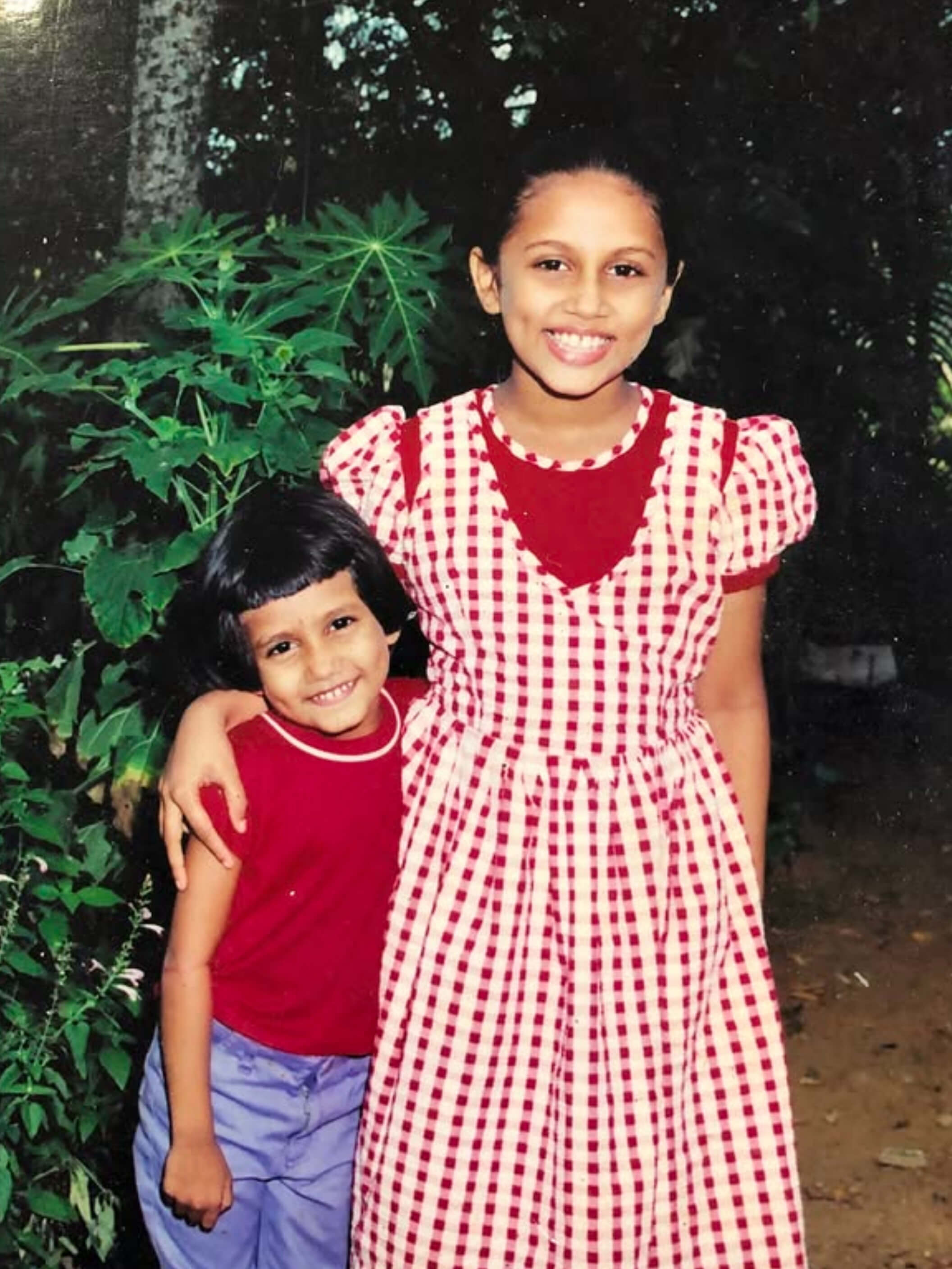 Laganna Jewelry Sri Lanka co-founders childhood photo - sister entrepreneurs origin story vintage photograph red gingham dress tropical garden - women-owned handcrafted jewelry brand family business heritage