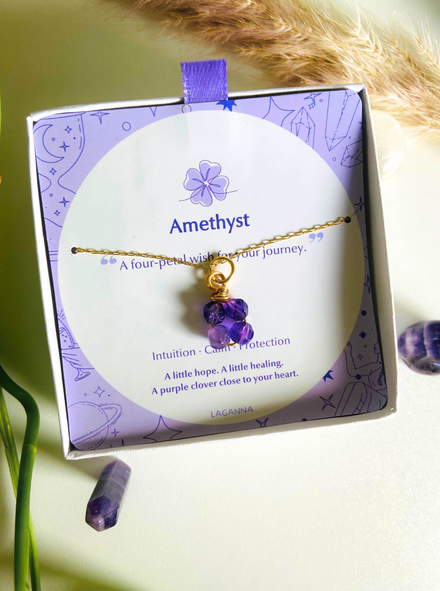 Beautiful amethyst clover necklace in aesthetic jewelry box presentation, featuring the lucky clover-shaped purple gemstone with gold wire wrapping - artisan-crafted healing crystal jewelry handmade in Sri Lanka by Laganna for peace and balance