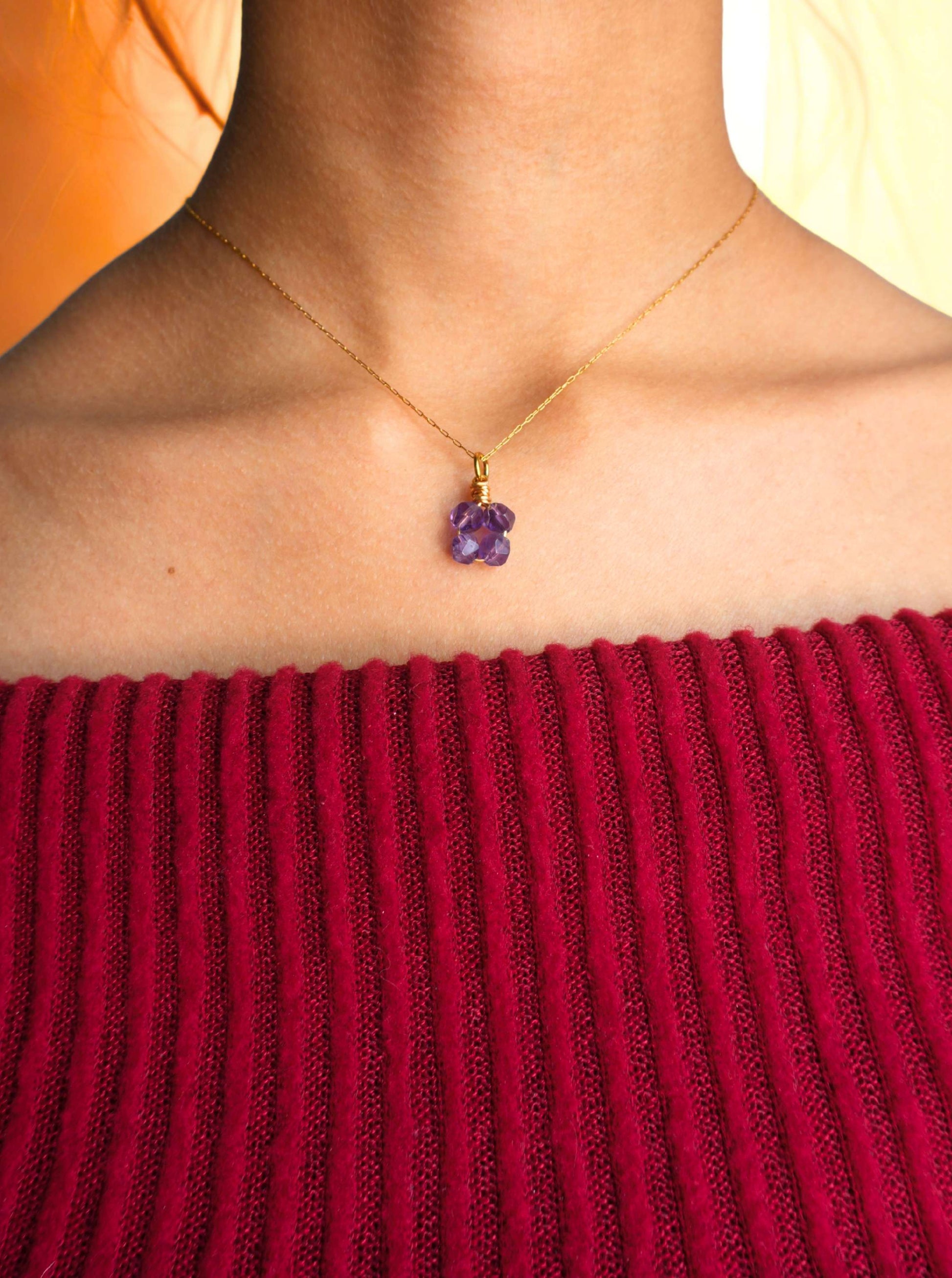 Detailed closeup of amethyst clover pendant necklace worn styling, highlighting the exquisite purple gemstone clover shape and gold wire wrapping craftsmanship - handmade healing crystal jewelry from Sri Lanka for calming energy and spiritual wellness