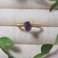 Natural amethyst irregular stone ring on jewelry display showing handmade gold wire wrapped healing crystal jewelry, Sri Lankan artisan spiritual ring with raw purple gemstone perfect as boho stress relief ring and third eye chakra amulet for meditation and tranquility