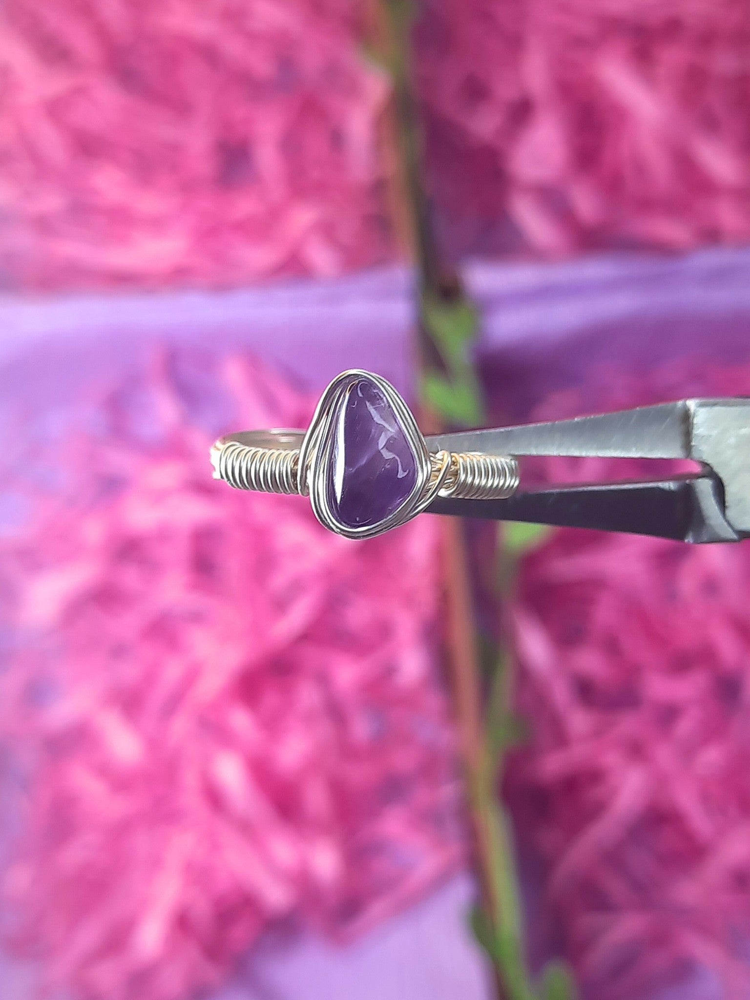  Handmade amethyst irregular stone ring in silver wire wrapped design featuring natural healing crystal jewelry crafted by Sri Lankan artisans as spiritual protection ring and third eye chakra balancing amulet for women seeking stress relief and better sleep with raw purple gemstone energy