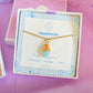Aquamarine irregular stone necklace jewelry box packaging front view, handmade Sri Lankan gold wire wrapped healing crystal pendant gift for tranquility