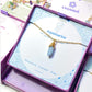 Aquamarine irregular stone necklace jewelry box side view, handmade Sri Lankan gold wire wrapped healing crystal pendant for throat chakra and emotional balance