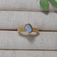Handmade aquamarine irregular stone ring in gold wire wrapped design featuring natural healing crystal jewelry crafted by Sri Lankan artisans as throat chakra balancing ring and communication enhancement amulet for women seeking clarity and emotional healing with raw blue gemstone energy