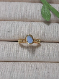Handmade aquamarine irregular stone ring in gold wire wrapped design featuring natural healing crystal jewelry crafted by Sri Lankan artisans as throat chakra balancing ring and communication enhancement amulet for women seeking clarity and emotional healing with raw blue gemstone energy