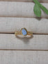 Handmade aquamarine irregular stone ring in gold wire wrapped design featuring natural healing crystal jewelry crafted by Sri Lankan artisans as throat chakra balancing ring and communication enhancement amulet for women seeking clarity and emotional healing with raw blue gemstone energy