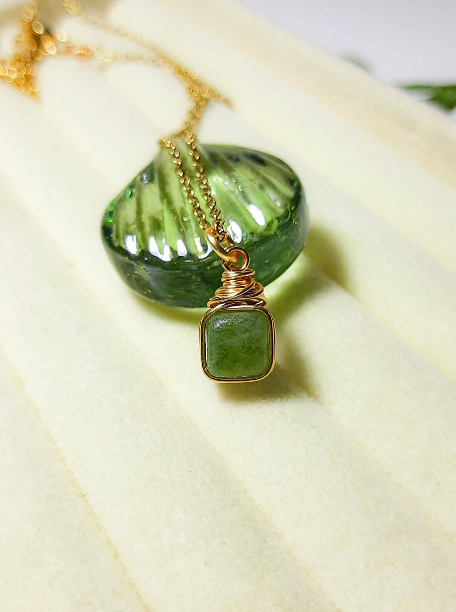 Olive jade square stone necklace in gold wire wrapped design showing handmade healing crystal jewelry, Sri Lankan artisan heart chakra pendant featuring natural square green gemstone perfect as boho abundance necklace and prosperity amulet for emotional balance and inner peace with geometric styling