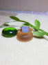 Handmade aquamarine square stone ring in gold wire wrap on jewelry display, Sri Lankan healing crystal jewelry for throat chakra balancing and communication enhancement