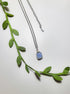 Natural aquamarine square stone necklace on white background showing handmade silver wire wrapped healing crystal jewelry, Sri Lankan artisan throat chakra pendant featuring geometric blue gemstone perfect as boho communication necklace and calming amulet for emotional balance and peace