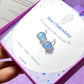 Two Blue Chalcedony Petite Round Stud Earrings on a laganna jewelry box showing wire-wrapped design and natural sky blue stones - handmade healing crystal jewelry from Sri Lanka