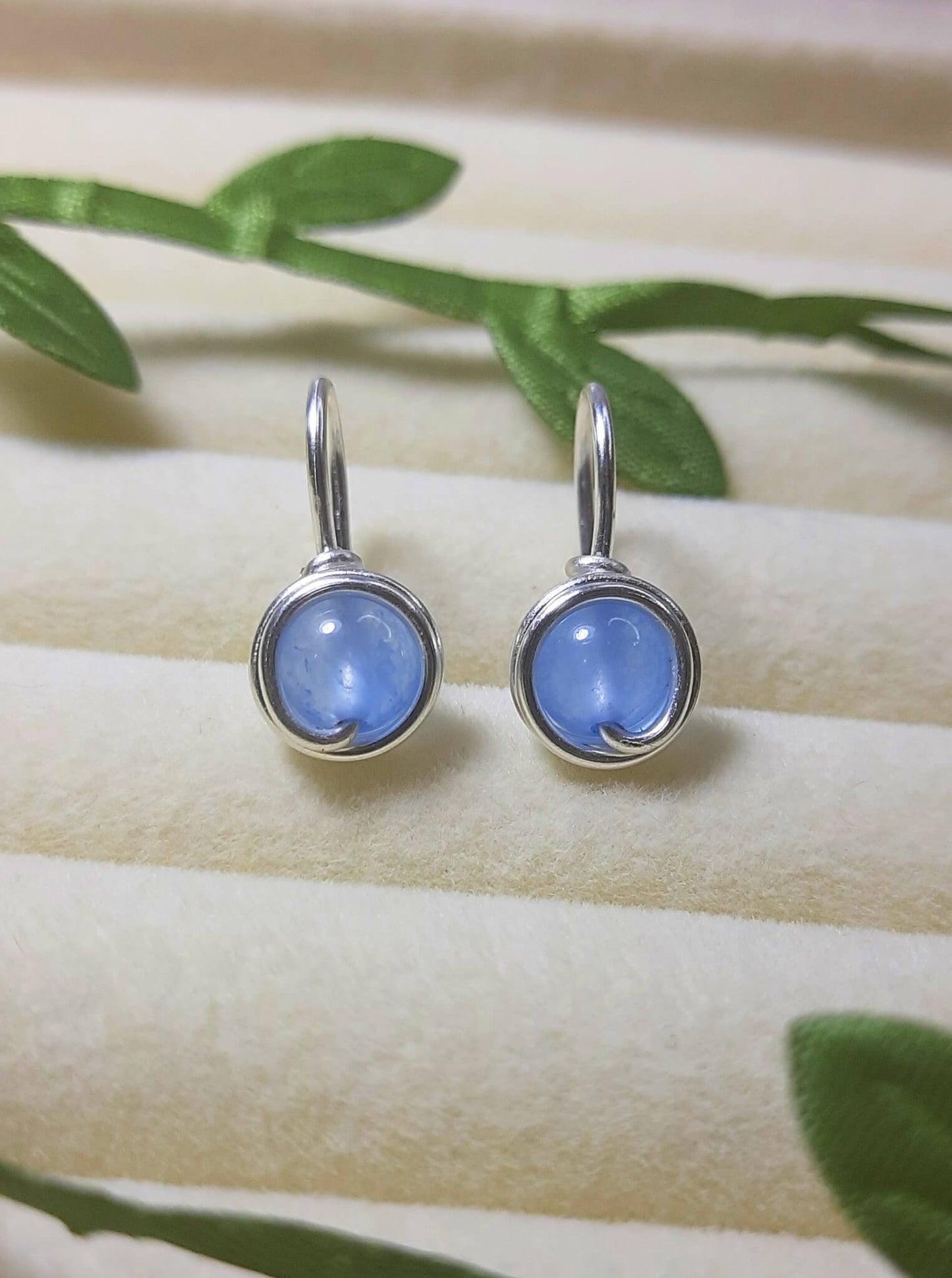 Pair of Blue Chalcedony Petite Round Stud Earrings with soft sky blue stones in wire-wrapped gold and silver settings - handmade crystal healing jewelry crafted in Sri Lanka for calm and inner peace