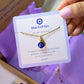 Blue evil eye necklace jewelry card held in hand showing handmade gold protection pendant packaging, Sri Lankan spiritual jewelry gift set featuring wire wrapped healing crystal necklace as evil eye talisman with elegant presentation for metaphysical jewelry lovers