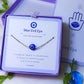 Blue evil eye silver bracelet with Laganna packaging showing handmade protection bracelet gift set, Sri Lankan spiritual jewelry featuring wire wrapped healing crystal design perfect as boho evil eye talisman and protective amulet for metaphysical jewelry lovers