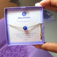 Blue evil eye bracelet jewelry box held in hand showing adjustable silver protection jewelry, handmade Sri Lankan spiritual bracelet with wire wrapped healing crystal design perfect as boho evil eye talisman and protective amulet for anxiety relief and metaphysical healing