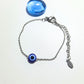 Handmade blue evil eye protection bracelet in adjustable silver wire wrapped design, featuring spiritual healing crystal jewelry crafted by Sri Lankan artisans as protective talisman and boho chic amulet for women seeking luck and anxiety relief