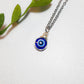 Handmade blue evil eye protection necklace in adjustable silver wire wrapped design, featuring spiritual healing crystal jewelry crafted by Sri Lankan artisans as protective talisman and boho chic pendant for women seeking anxiety relief and chakra balancing