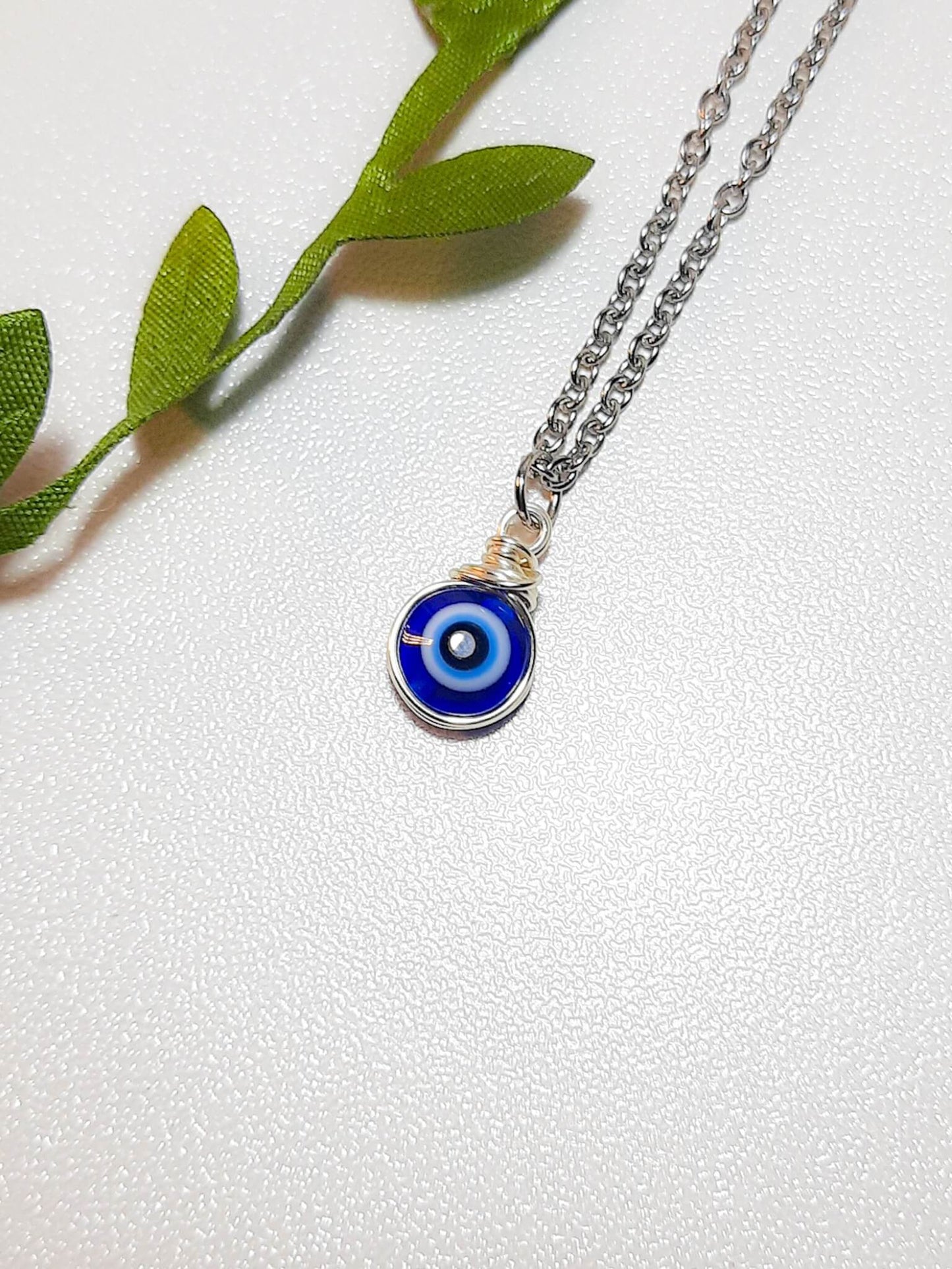 Handmade blue evil eye protection necklace in adjustable silver wire wrapped design, featuring spiritual healing crystal jewelry crafted by Sri Lankan artisans as protective talisman and boho chic pendant for women seeking anxiety relief and chakra balancing