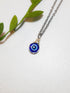Handmade blue evil eye protection necklace in adjustable silver wire wrapped design, featuring spiritual healing crystal jewelry crafted by Sri Lankan artisans as protective talisman and boho chic pendant for women seeking anxiety relief and chakra balancing