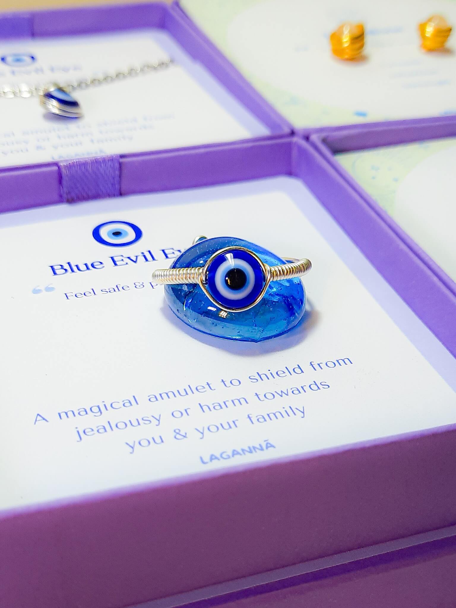 Blue evil eye ring with elegant Laganna jewelry box showing handmade silver protection ring packaging, Sri Lankan artisan spiritual jewelry gift set featuring wire wrapped healing crystal ring as evil eye talisman with premium presentation box