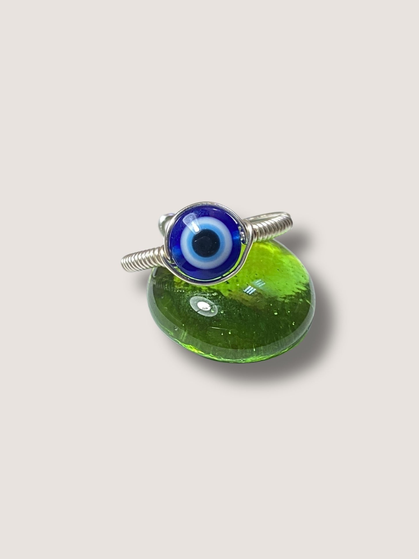  Blue evil eye protection ring on white background showing handmade silver wire wrapped spiritual jewelry, Sri Lankan artisan crafted evil eye talisman featuring healing crystal design perfect as boho protective amulet and anxiety relief ring for metaphysical jewelry enthusiasts seeking chakra balancing