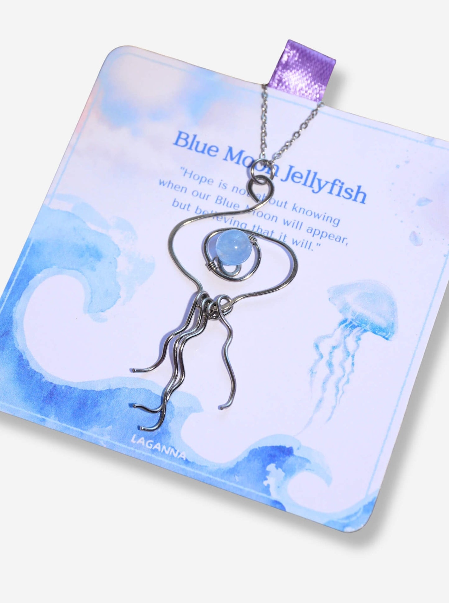 Blue Moon Jellyfish Necklace closeup showing hand sculpted stainless steel wire tentacles and Blue Chalcedony stone Laganna artisan jewelry handmade Sri Lanka calm clarity hope healing crystal pendant

