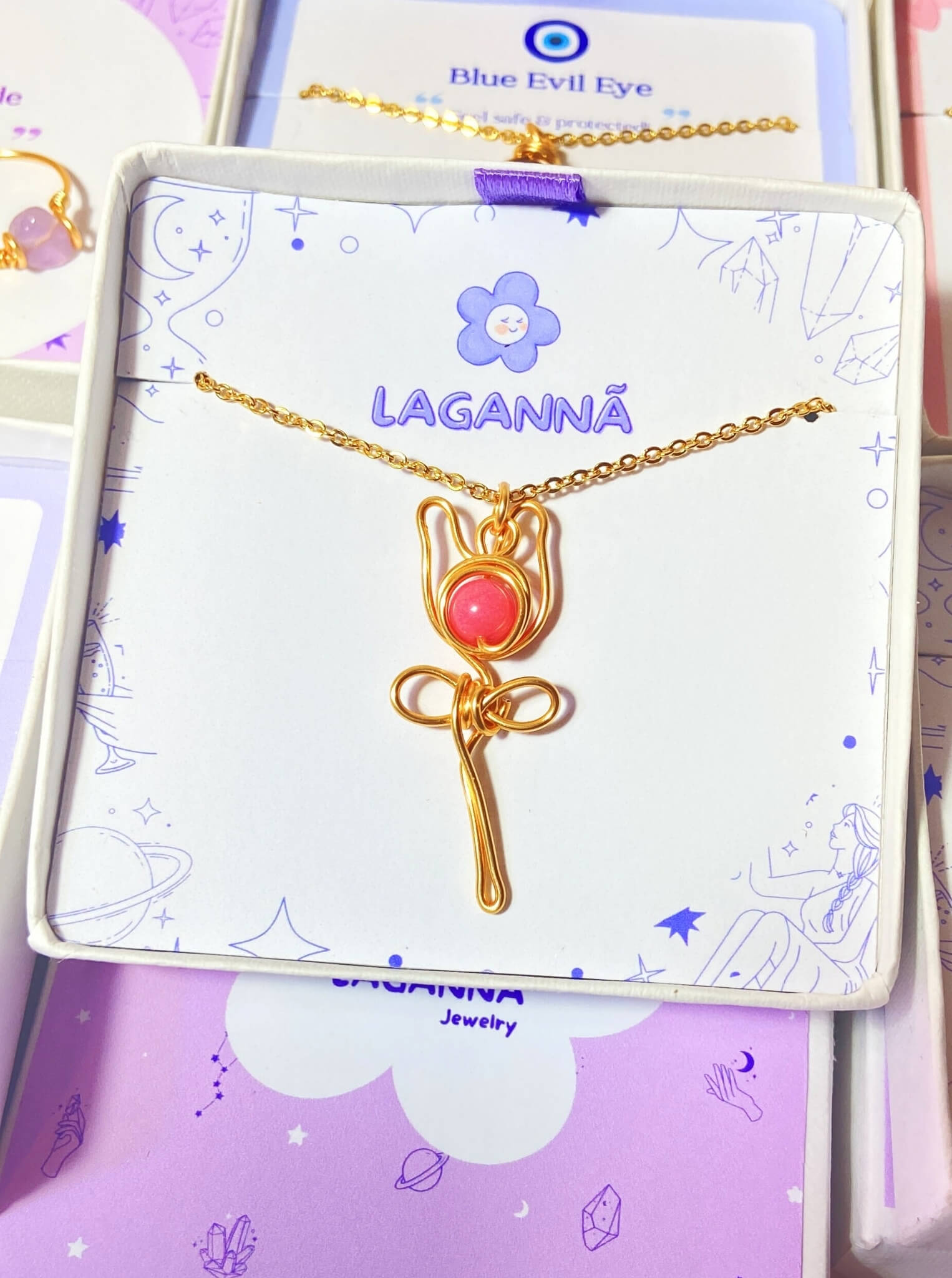 Stylish pink chalcedony rose pendant necklace in aesthetic flat lay styling, highlighting the minimalist gold wire wrapped design - handmade healing crystal jewelry from Sri Lanka for feminine accessory lovers