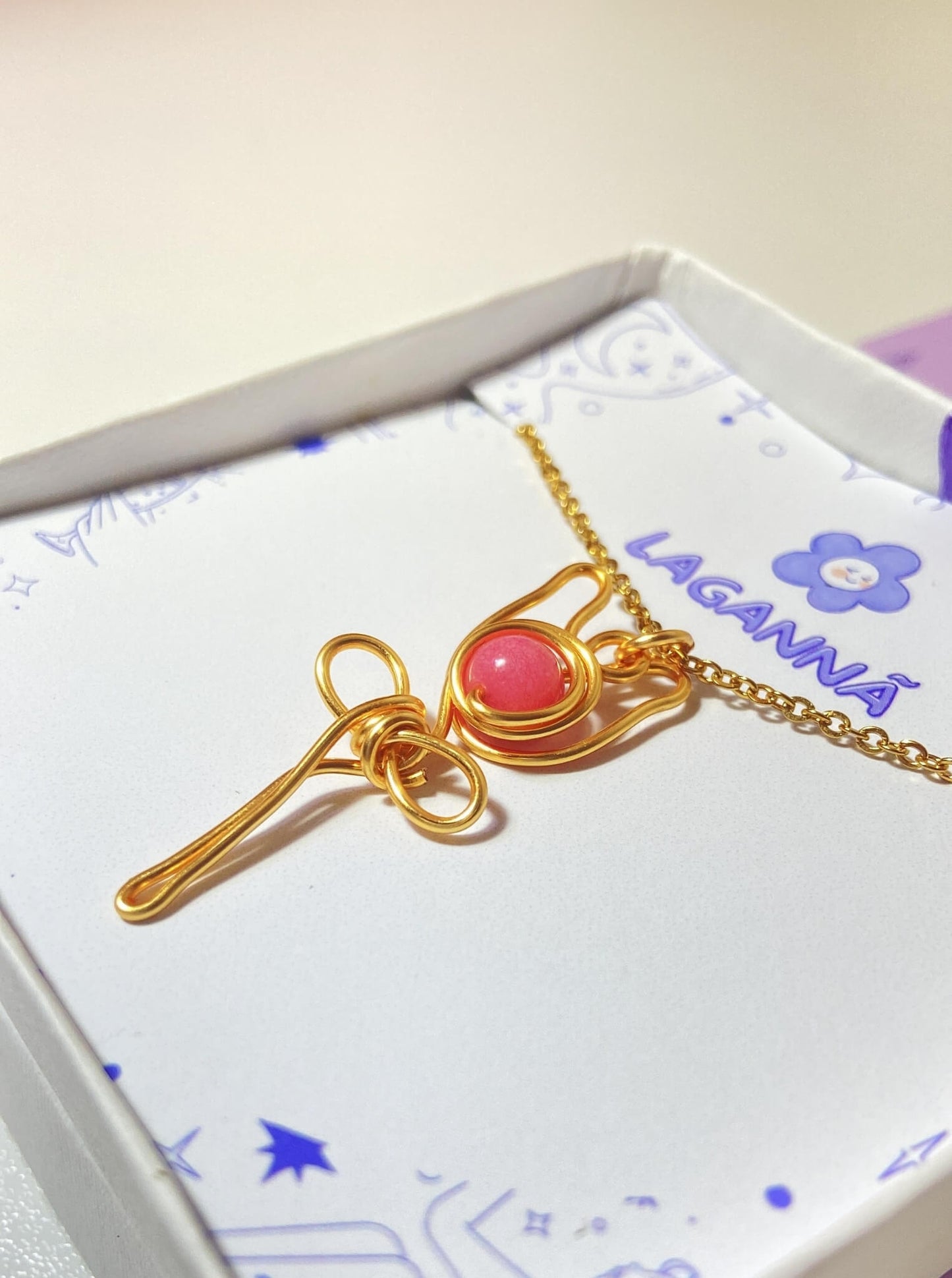 Detailed closeup of pink chalcedony rose pendant showing exquisite gold wire wrapping craftsmanship - handmade healing crystal jewelry by Sri Lankan artisans at Laganna, showcasing quality feminine gift details