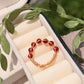 Carnelian braided gold wire ring top view in jewelry box, handmade healing crystal ring for confidence and personal power, Laganna Sri Lanka