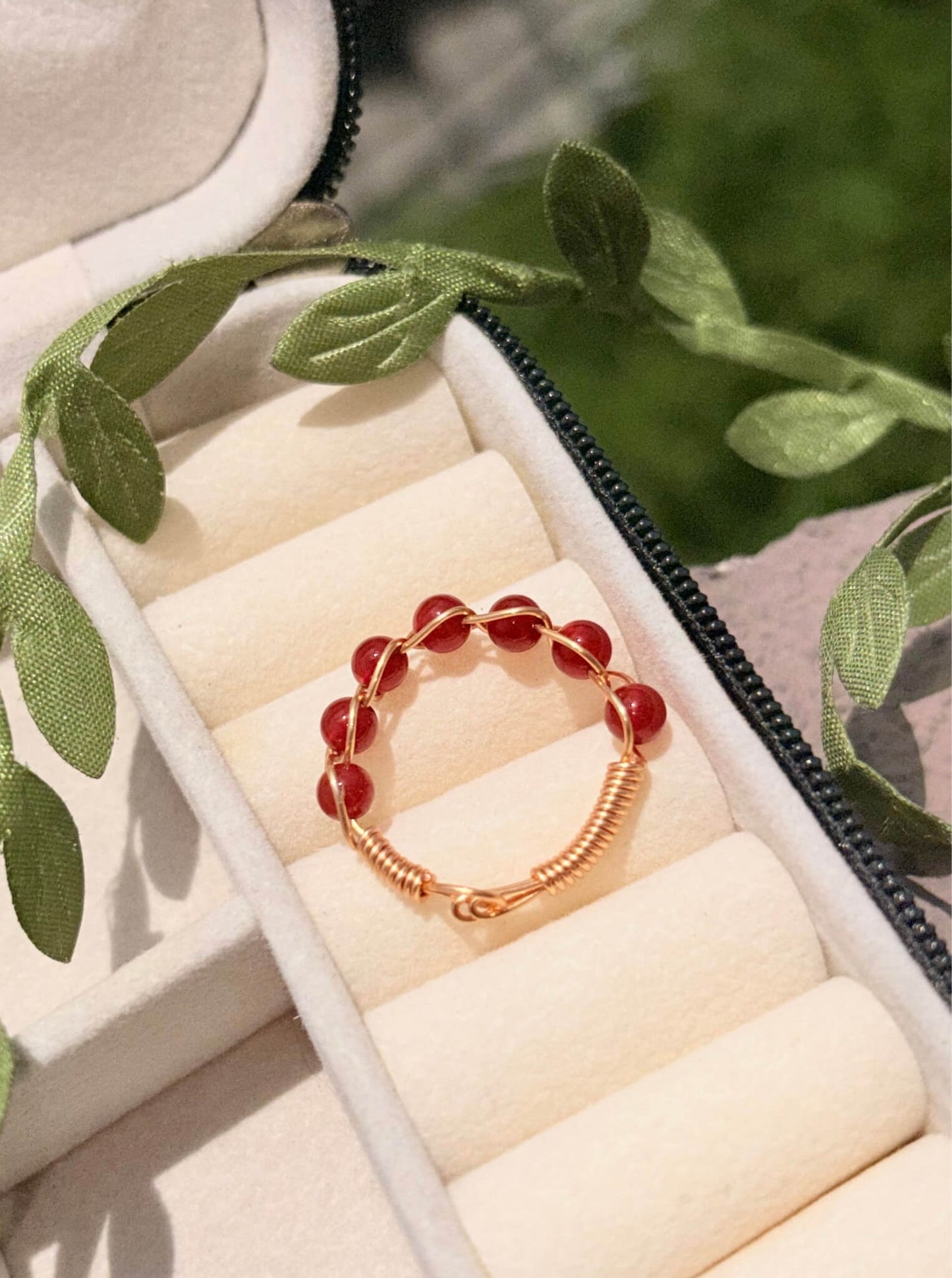 Carnelian braided gold wire ring top view in jewelry box, handmade healing crystal ring for confidence and personal power, Laganna Sri Lanka