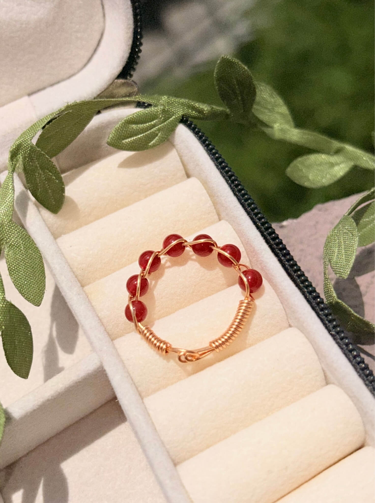 Carnelian braided gold wire ring top view in jewelry box, handmade healing crystal ring for confidence and personal power, Laganna Sri Lanka