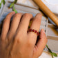 Carnelian braided ring worn on hand showing gold wire wrapped design, handmade Sri Lankan healing crystal ring lifestyle for confidence and motivation