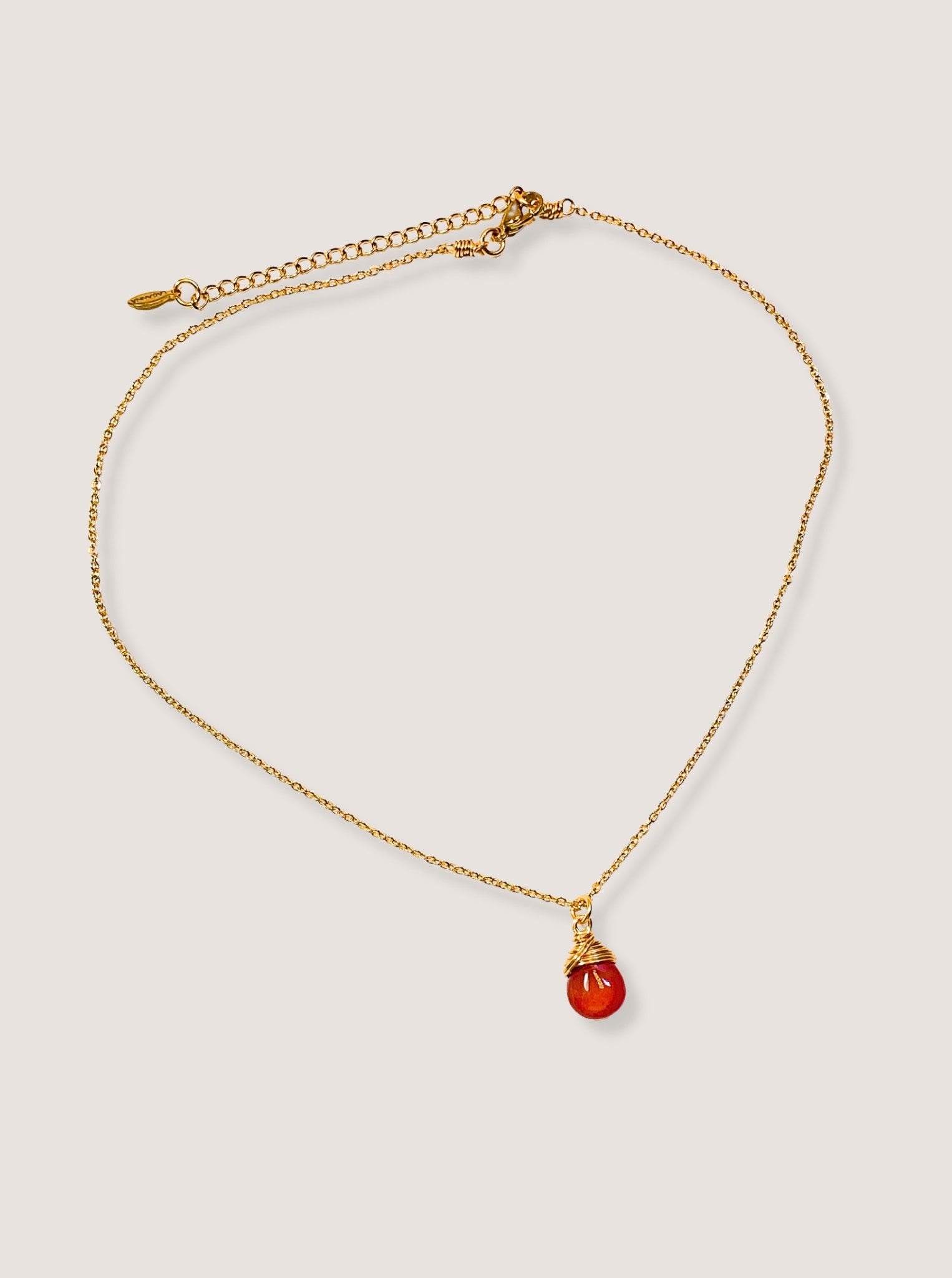 Carnelian drop necklace full look showing handmade gold wire wrapped healing crystal pendant, Sri Lankan spiritual jewelry featuring natural orange gemstone perfect as boho statement necklace and protective amulet for confidence and creative energy enhancement