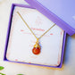 Handmade carnelian drop necklace in elegant jewelry box with natural leaves, gold wire wrapped healing crystal pendant featuring Sri Lankan spiritual jewelry craftsmanship perfect as boho gemstone statement necklace and protective amulet for confidence and creative energy with premium packaging