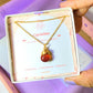 Carnelian drop necklace with elegant Laganna jewelry box held in hand showing premium packaging, handmade gold healing crystal pendant gift set featuring Sri Lankan artisan spiritual jewelry perfect as gemstone statement necklace gift for confidence and creativity
