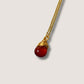 Carnelian drop necklace close-up detail showing handmade gold wire wrapped healing crystal pendant, natural orange gemstone jewelry crafted by Sri Lankan artisans featuring intricate metalwork perfect as spiritual statement necklace for confidence and creative energy activation