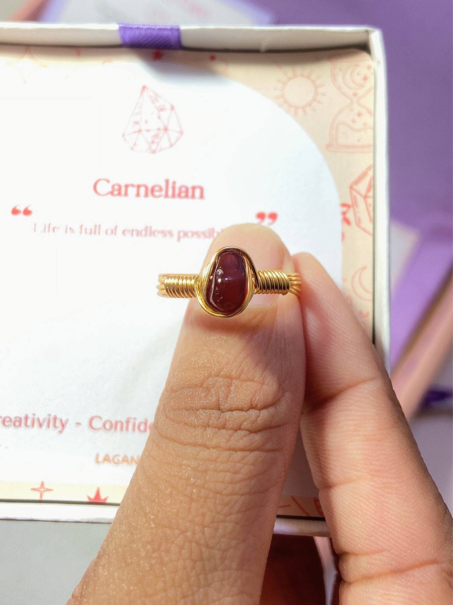 Carnelian irregular stone ring jewelry box held in hand showing handmade gold wire wrapped healing crystal gift set, Sri Lankan artisan creativity stone ring featuring natural orange gemstone perfect as courage jewelry gift for motivation and confidence enhancement with premium packaging