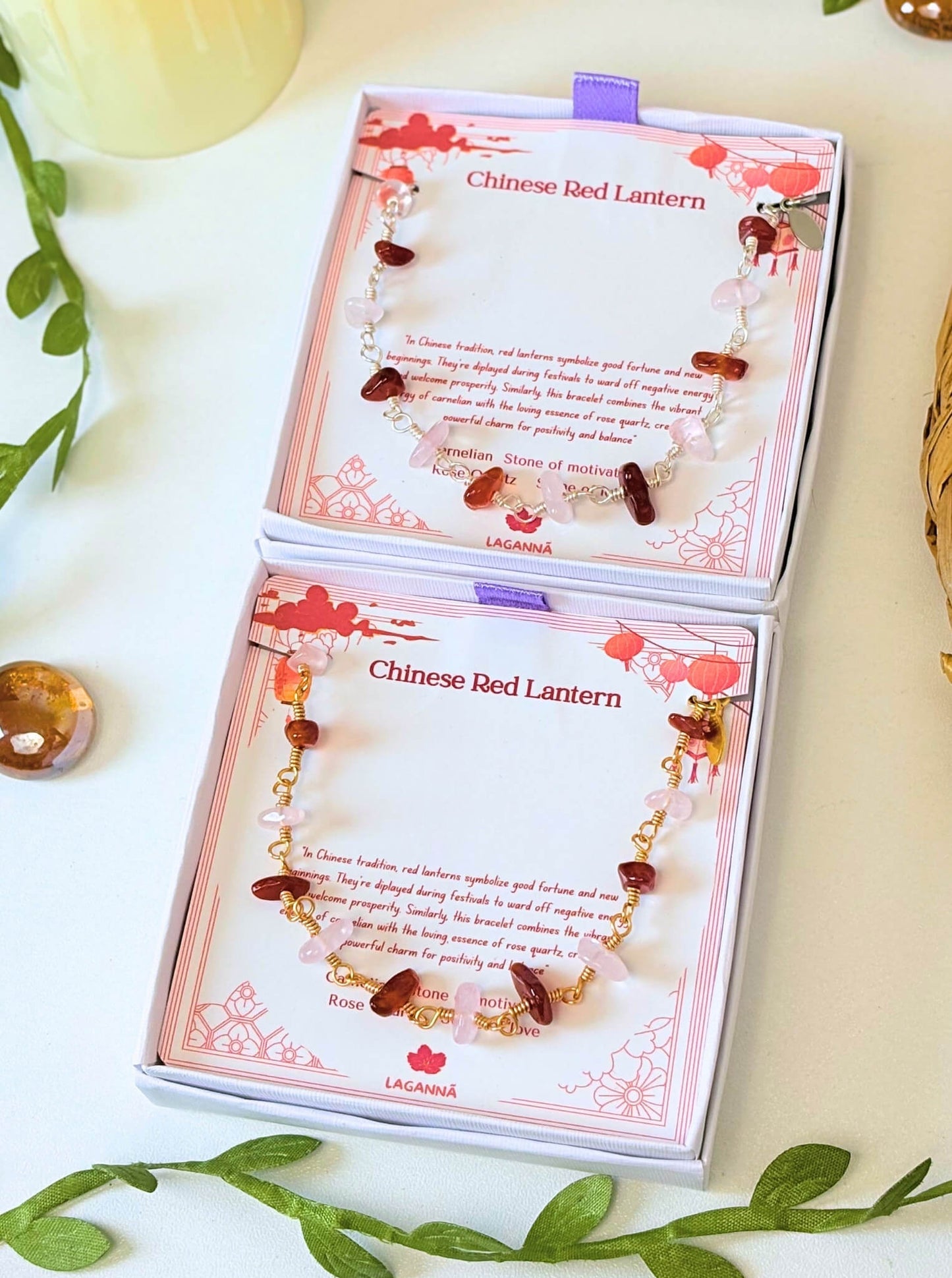 Chinese Red Lantern Bracelet gold and silver variants carnelian rose quartz wire wrapped displayed in open Laganna gift boxes side by side with green leaves styling, handmade healing crystal bracelet Sri Lanka – good fortune love positivity
