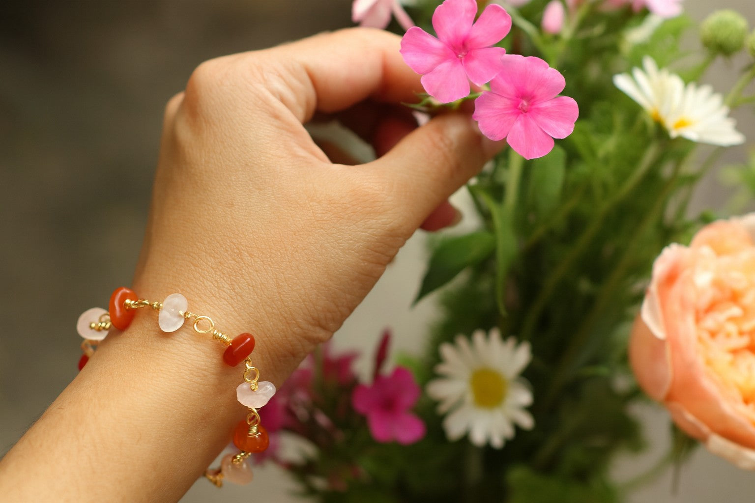 Chinese Red Lantern Bracelet worn while arranging flowers, highlighting natural beauty
