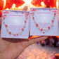 Beautiful Chinese Red Lantern healing crystal bracelet held in hands against traditional festive Chinese background, featuring carnelian rose quartz gold wire wrapped design - handmade spiritual jewelry from Sri Lanka inspired by Chinese lantern festivals for prosperity and joy