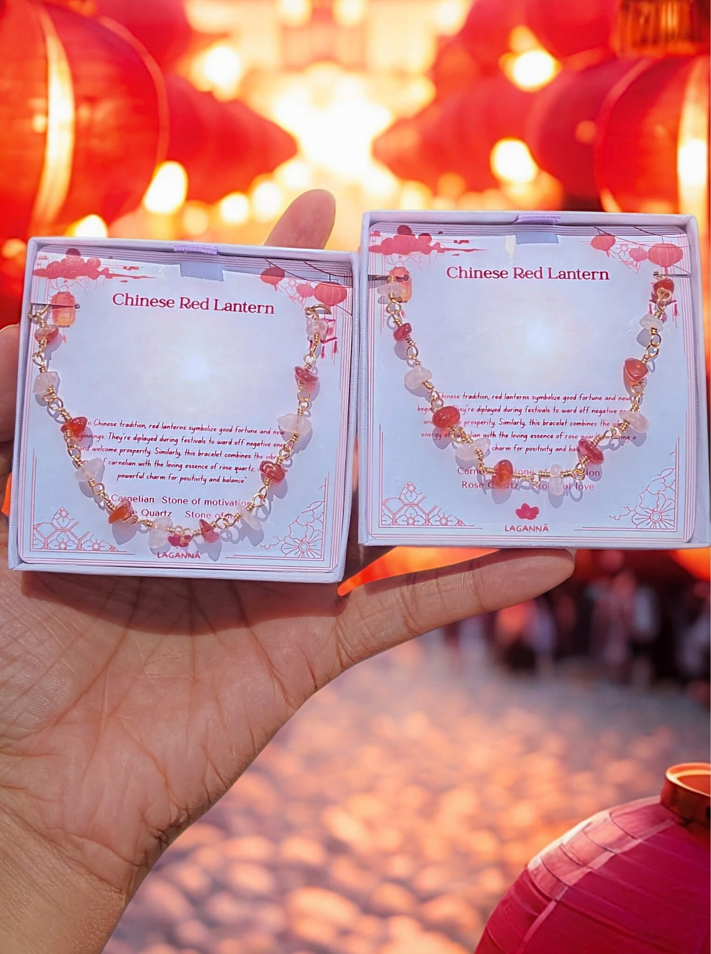 Beautiful Chinese Red Lantern healing crystal bracelet held in hands against traditional festive Chinese background, featuring carnelian rose quartz gold wire wrapped design - handmade spiritual jewelry from Sri Lanka inspired by Chinese lantern festivals for prosperity and joy