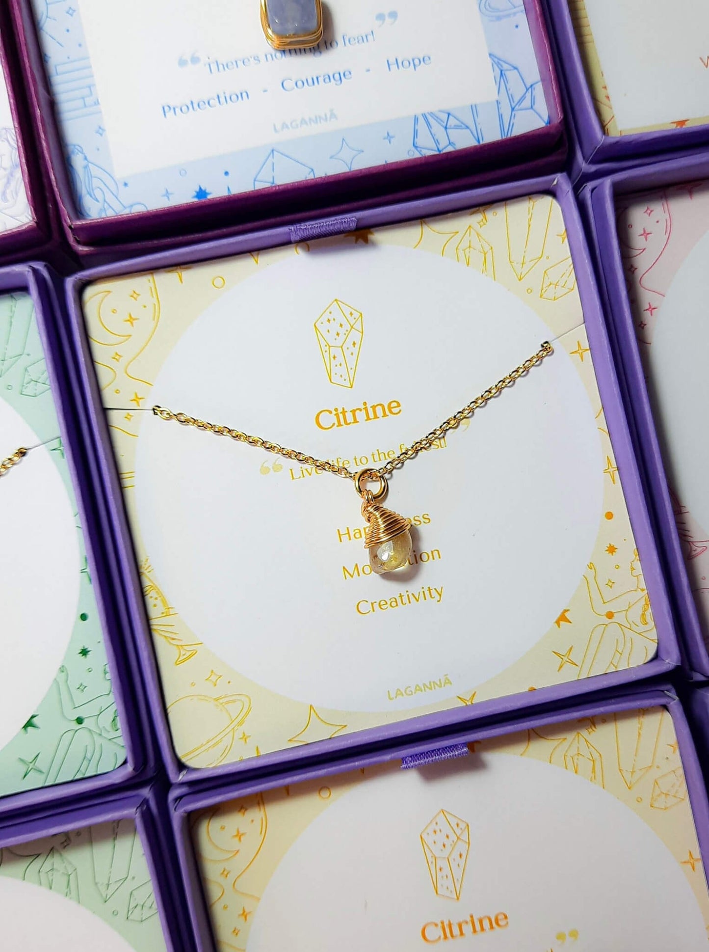 Citrine irregular stone necklace jewelry box stacked side view, handmade Sri Lankan gold wire wrapped healing crystal pendant for creativity and motivation