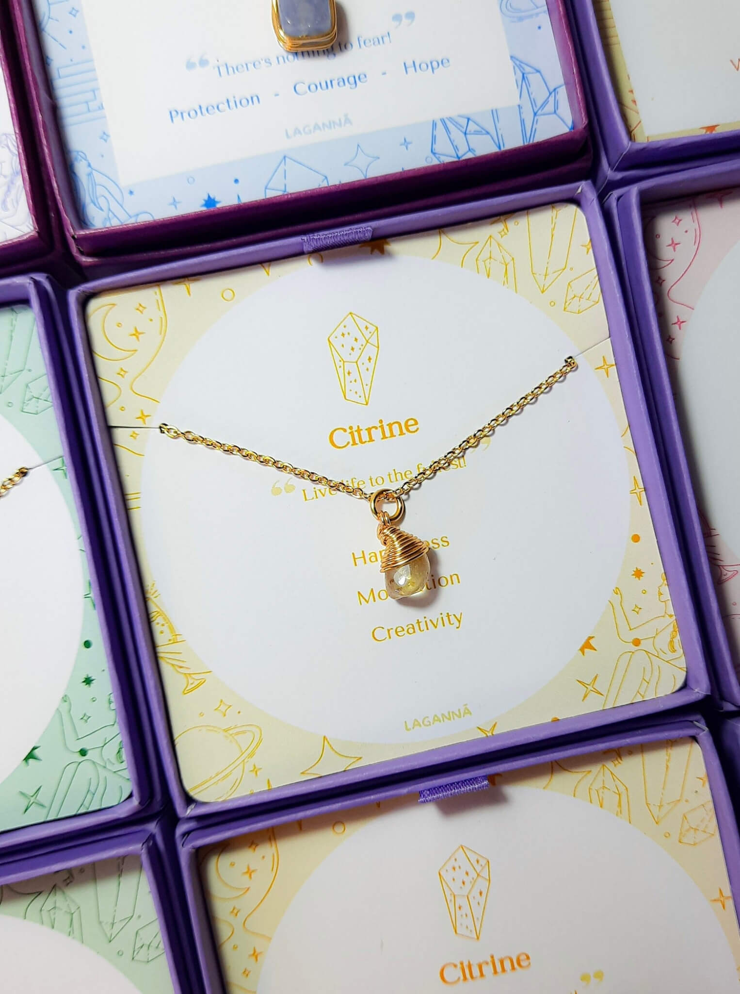 Citrine irregular stone necklace jewelry box stacked side view, handmade Sri Lankan gold wire wrapped healing crystal pendant for creativity and motivation