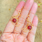 Crescent moon dangle earrings with carnelian held on hand, handmade Sri Lankan gold wire wrapped celestial earrings for sacral chakra and creative energy