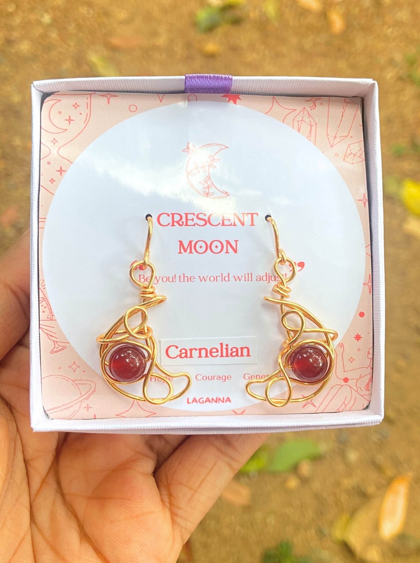 Crescent moon dangle earrings with carnelian in jewelry box, handmade Sri Lankan gold wire wrapped celestial earrings for confidence and motivation