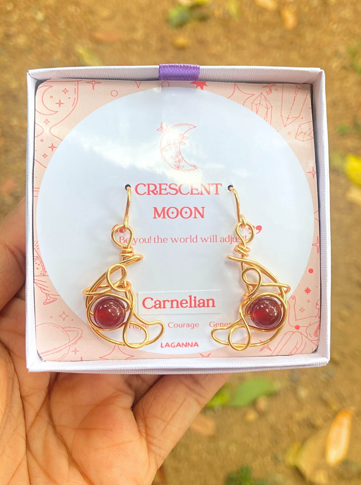 Crescent moon dangle earrings with carnelian in jewelry box, handmade Sri Lankan gold wire wrapped celestial earrings for confidence and motivation