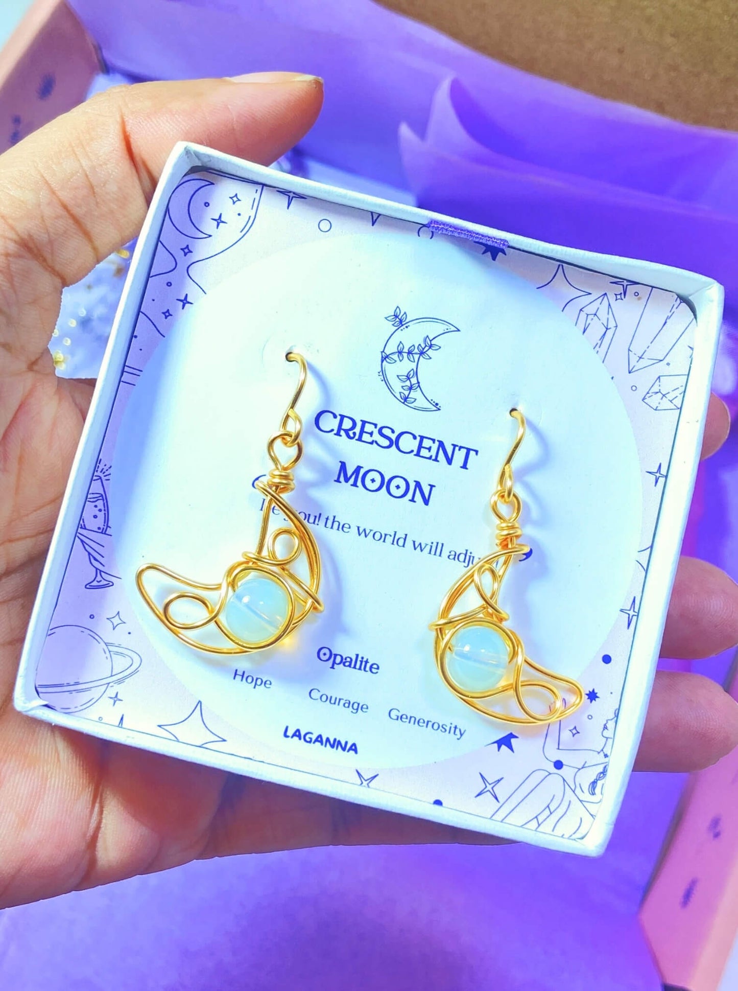 Close-up of Crescent Moon Dangle Earrings with Opalite healing crystals, handmade gold wire wrapped celestial jewelry from Sri Lanka by Laganna, beautifully packaged as meaningful spiritual gifts