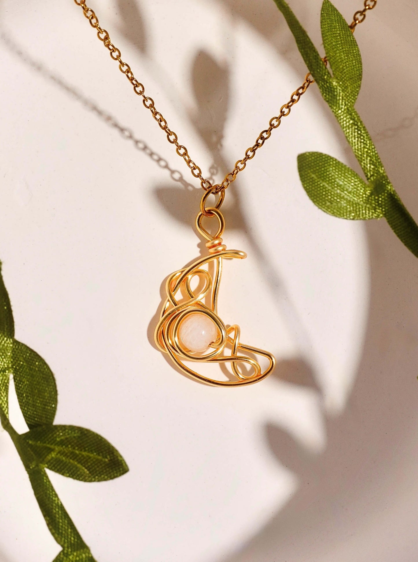 Crescent Moon Necklace Moonstone gold wire wrapped crescent pendant with green botanical leaves natural styling, handmade healing crystal jewelry Sri Lanka Laganna