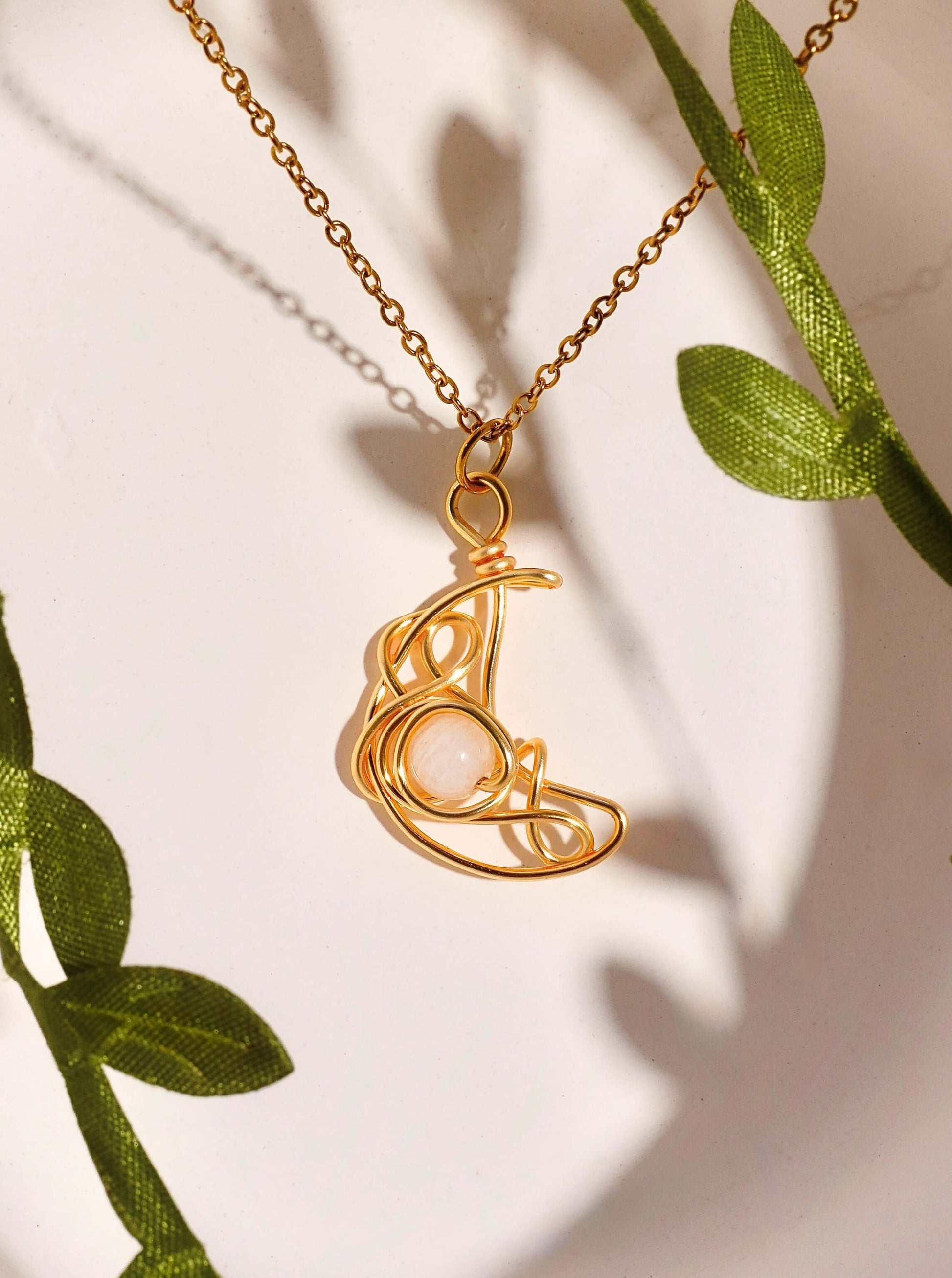 Crescent Moon Necklace Moonstone gold wire wrapped crescent pendant with green botanical leaves natural styling, handmade healing crystal jewelry Sri Lanka Laganna
